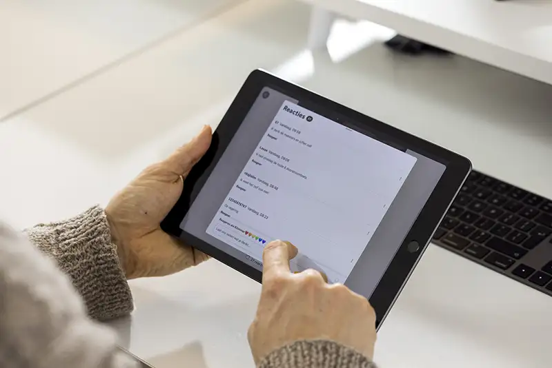 Photo of a tablet held in a hand